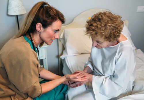 Doctor giving encouragement to elderly patient