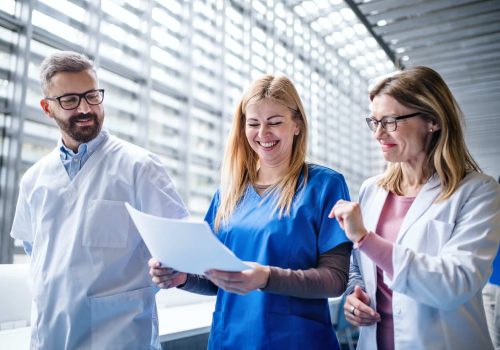 Group of doctors walking in corridor on medical conference