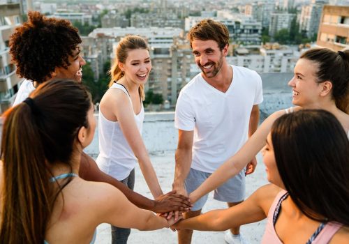 Group of fit healthy friends, people exercising together outdoor